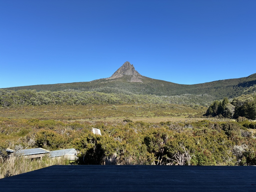 Sitting on the porch of Waterfall Valley Hut, looking at Barn Bluff